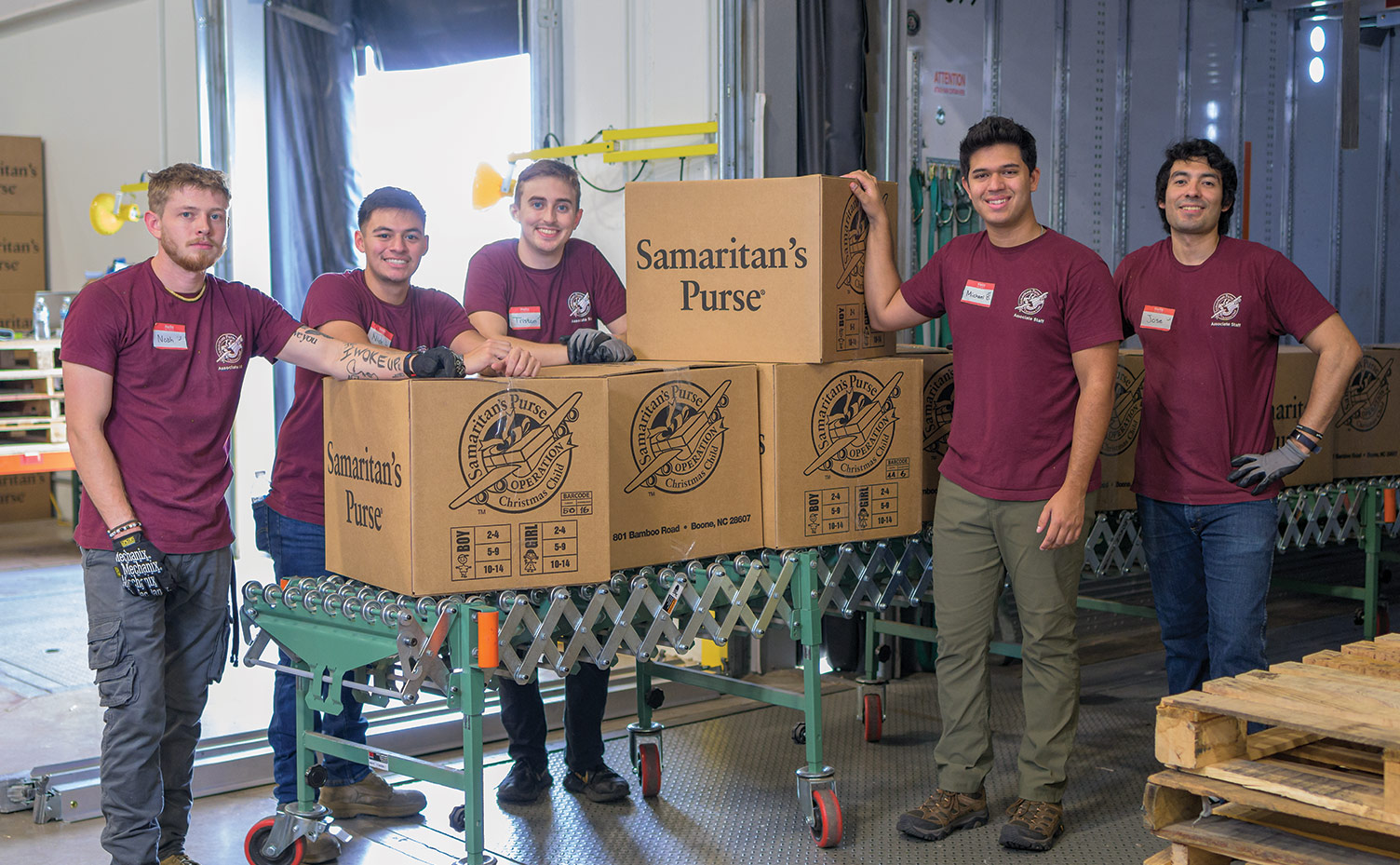 Operation Christmas Child Seasonal Employees prepare boxes to be loaded.