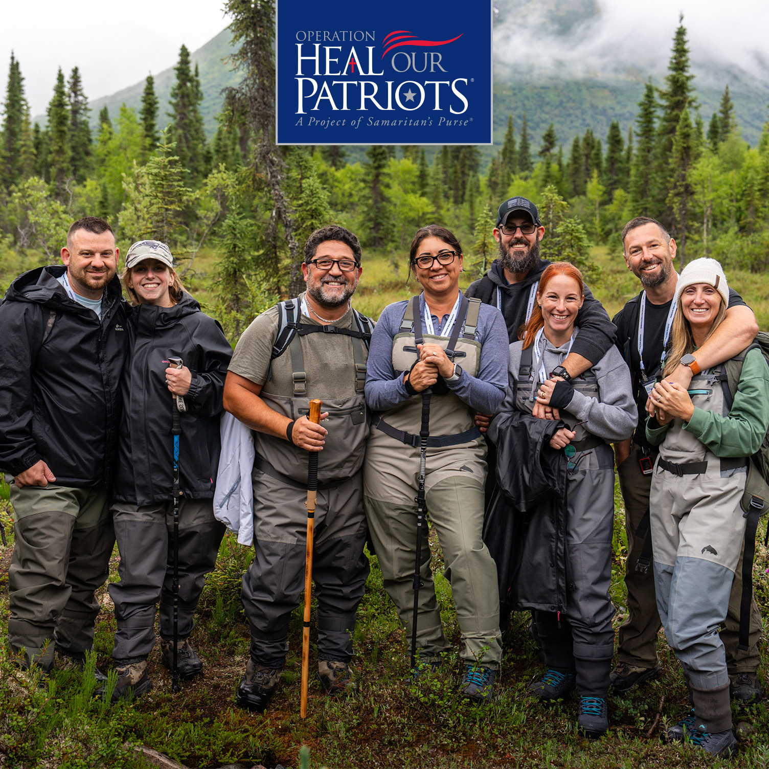 Four couples standing in front of a mountain.