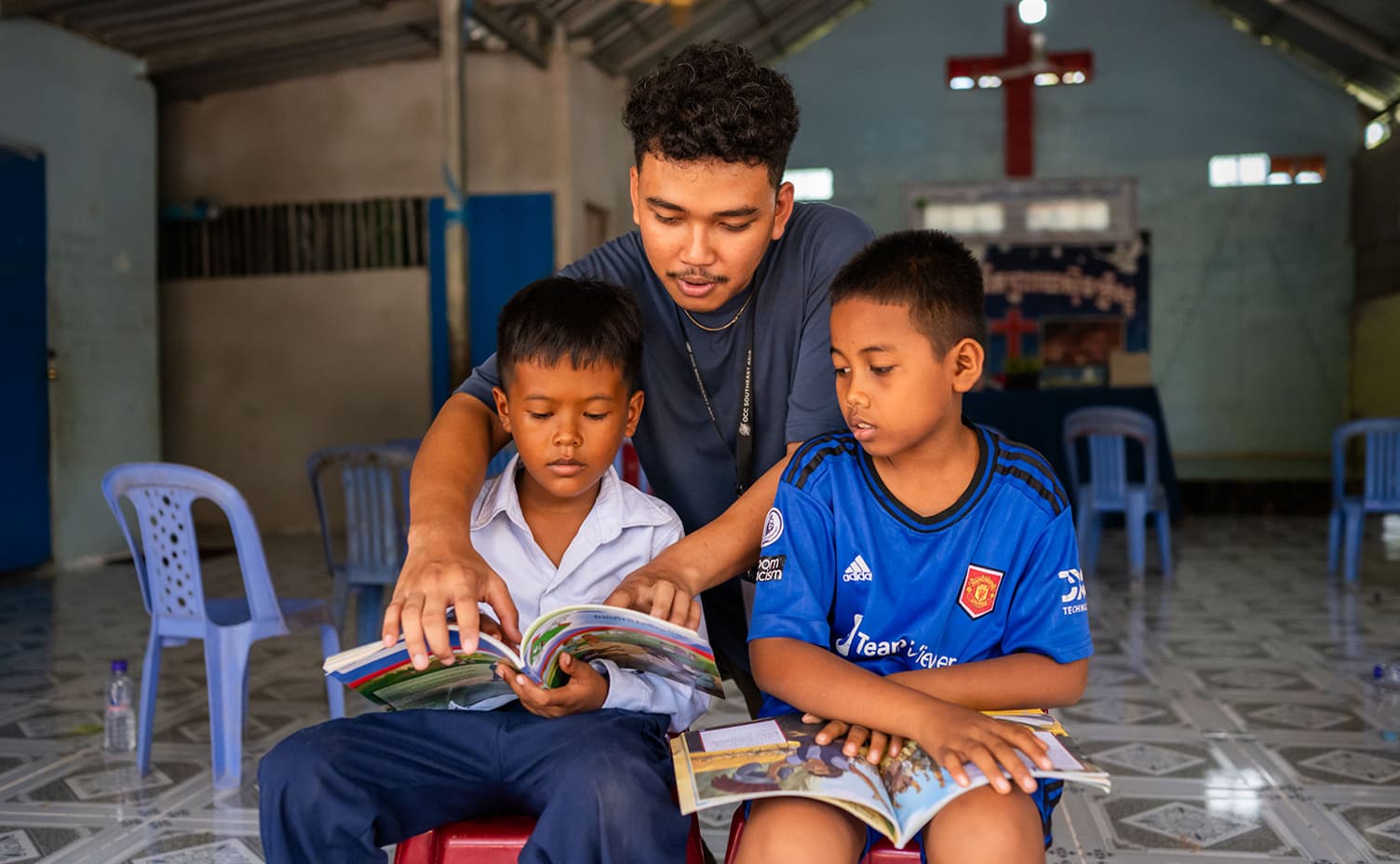 Man teaching two boys about Jesus Christ.