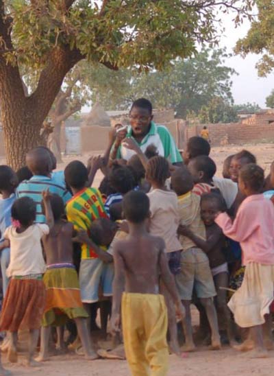 Désiré at a distribution with children