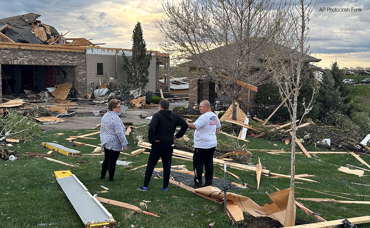 Homeowners assess damage after a tornado caused extensive damage in their neighborhood northwest of Omaha in Bennington, Neb., Friday, April 26, 2024. (AP Photo/Josh Funk)