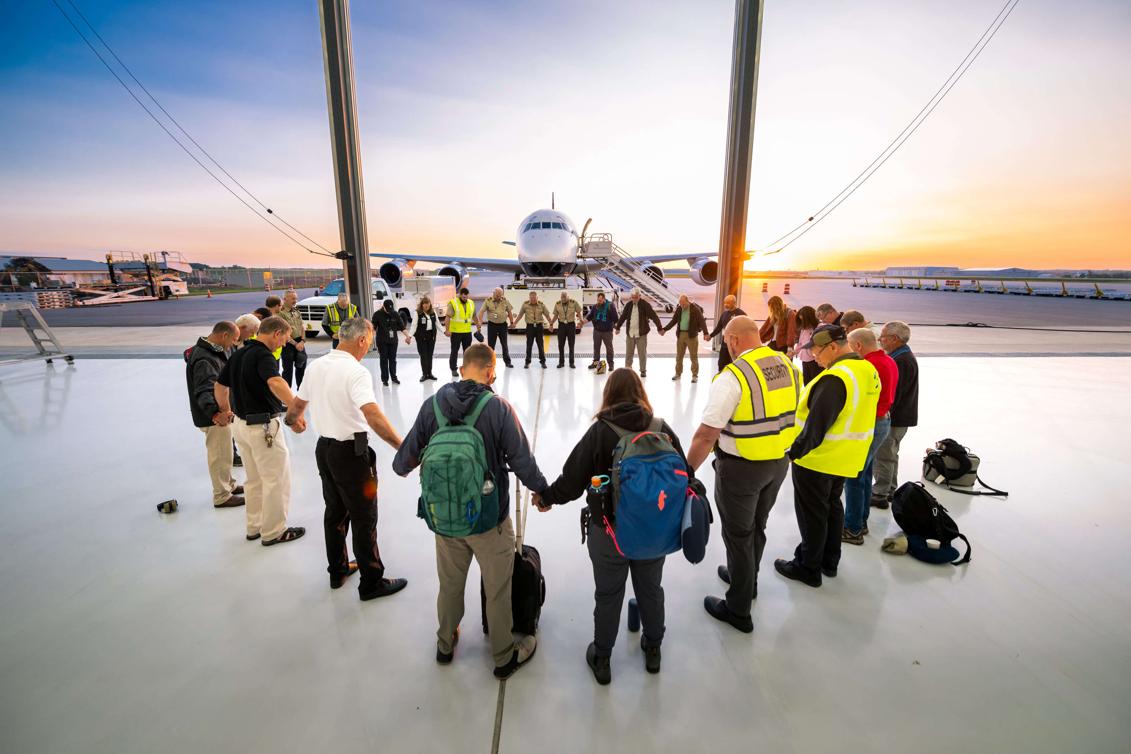 Individuals loading a plane with supplies.