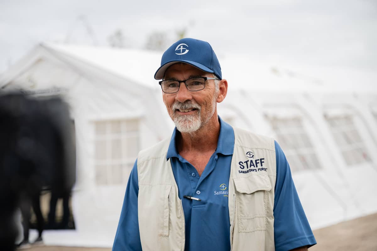 A man smiling in a Samaritan's Purse staff vest