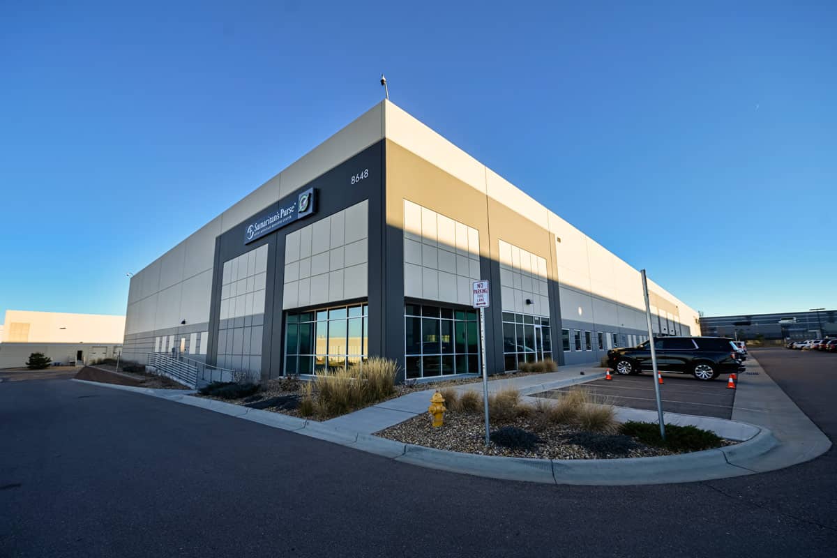 A grey and white square building.