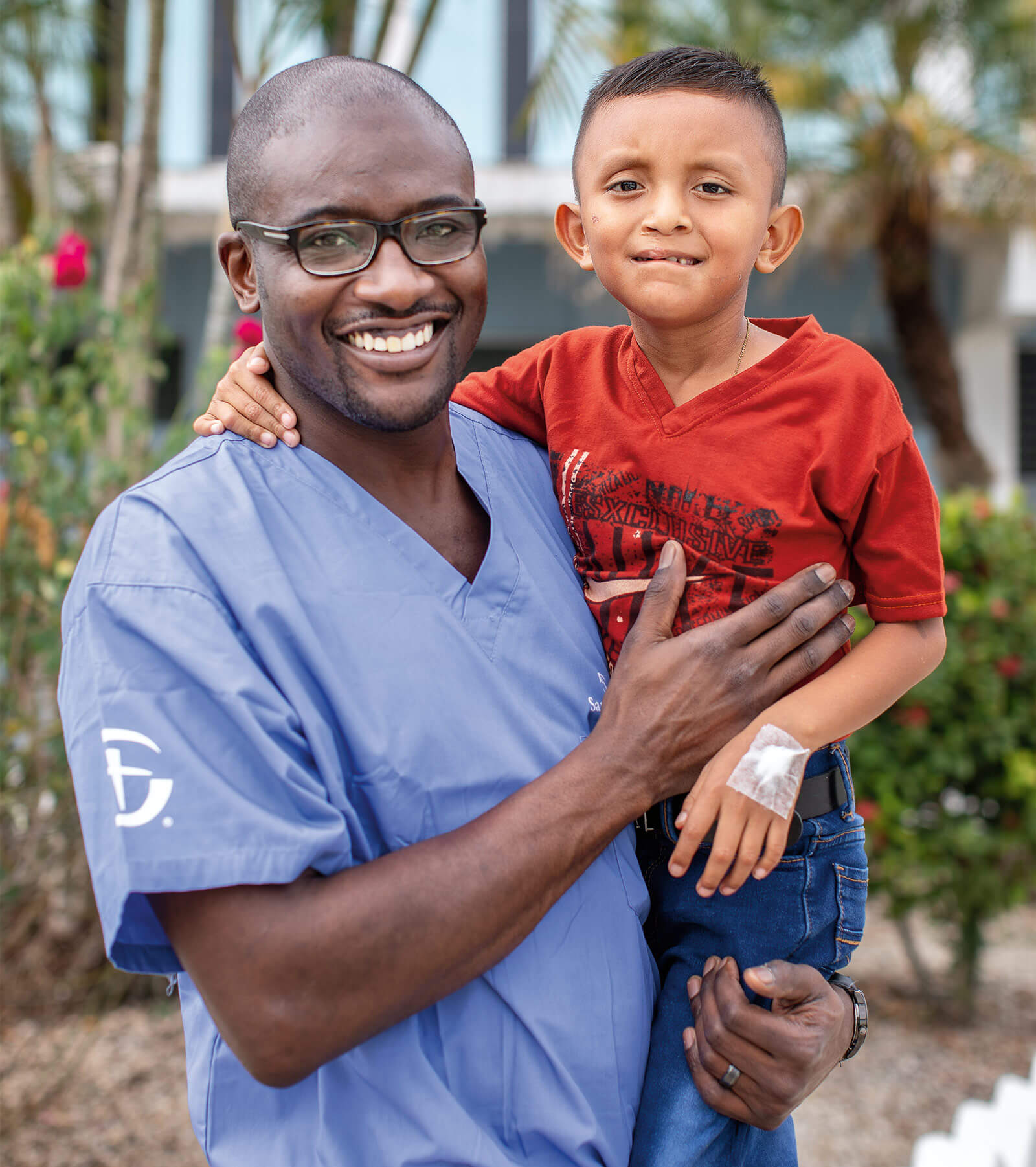 Surgeon smiling with little boy.