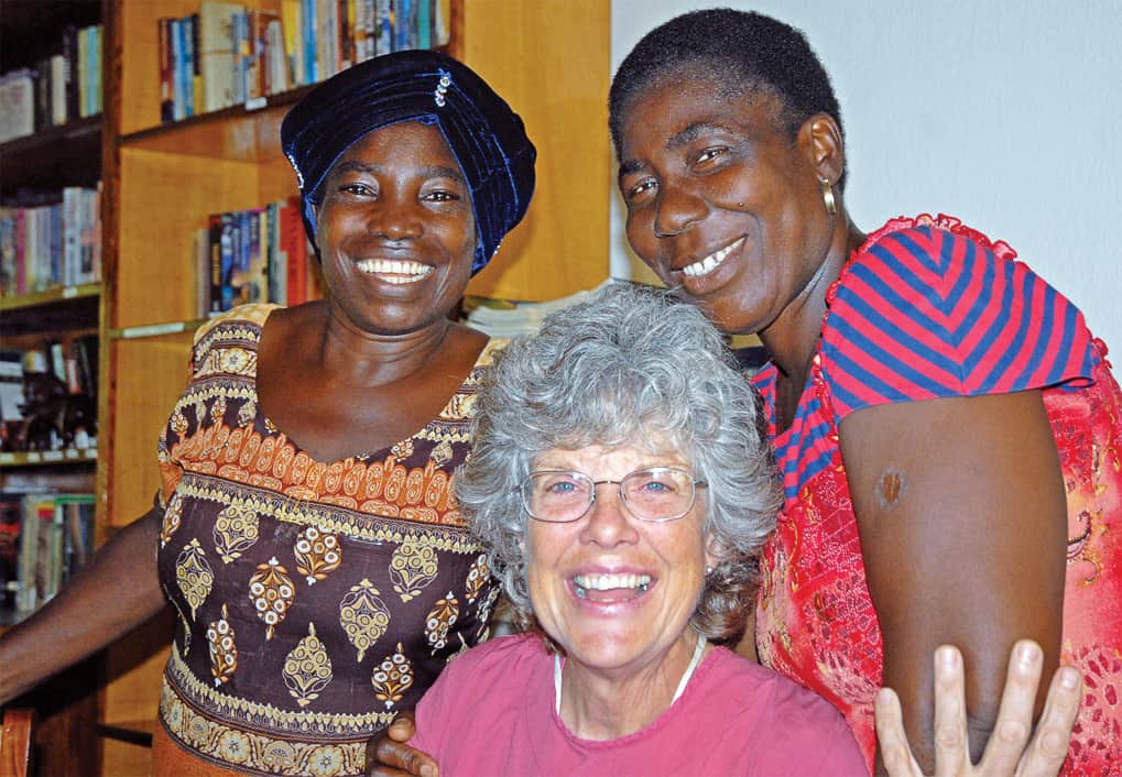 Three women smiling and posing for the camera.