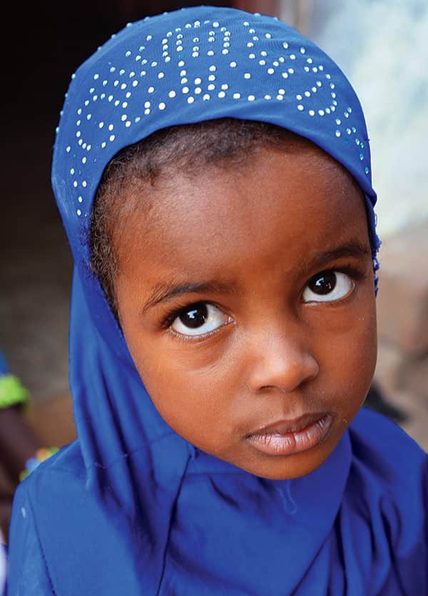 Young girl in blue wrap.